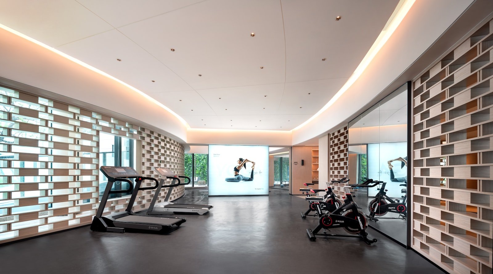 Modern light-filled exercise and rehab space with treadmills and bikes