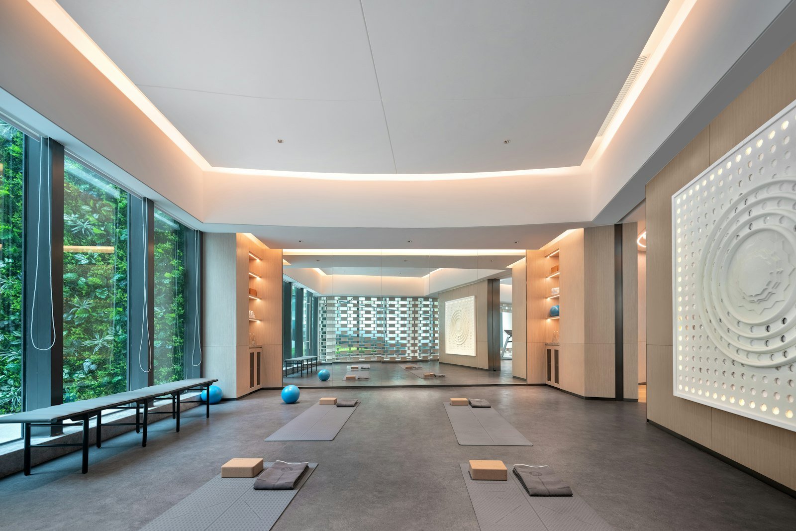 Bright modern movement studio with exercise mats, balls and large windows