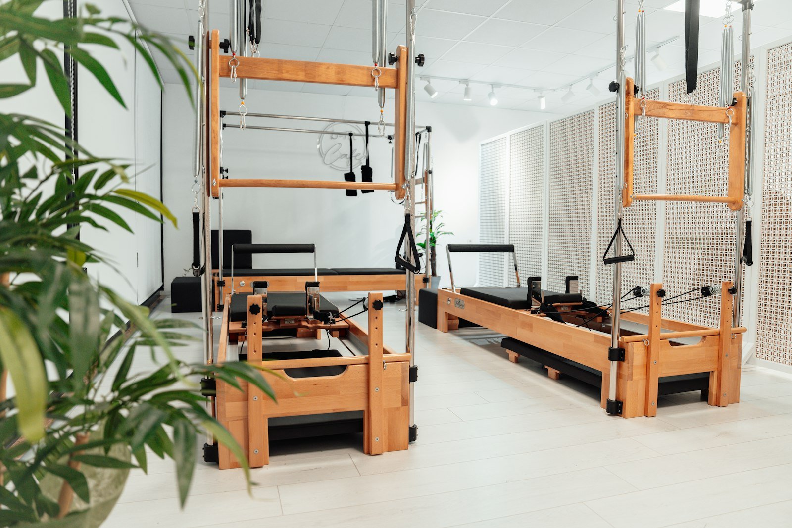 Pilates reformer and rehab equipment in a bright clinical exercise studio